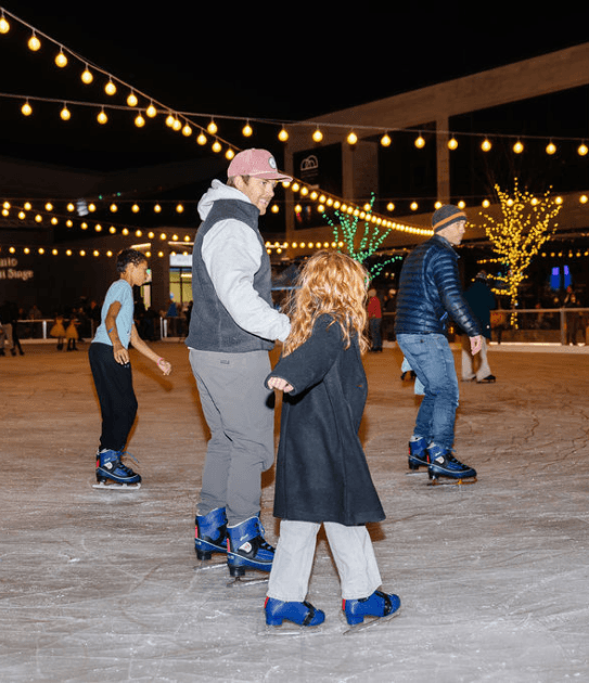 Father and Daughter Ice Skating at the Ice Rink at Daybreak's Winter Village in South Jordan