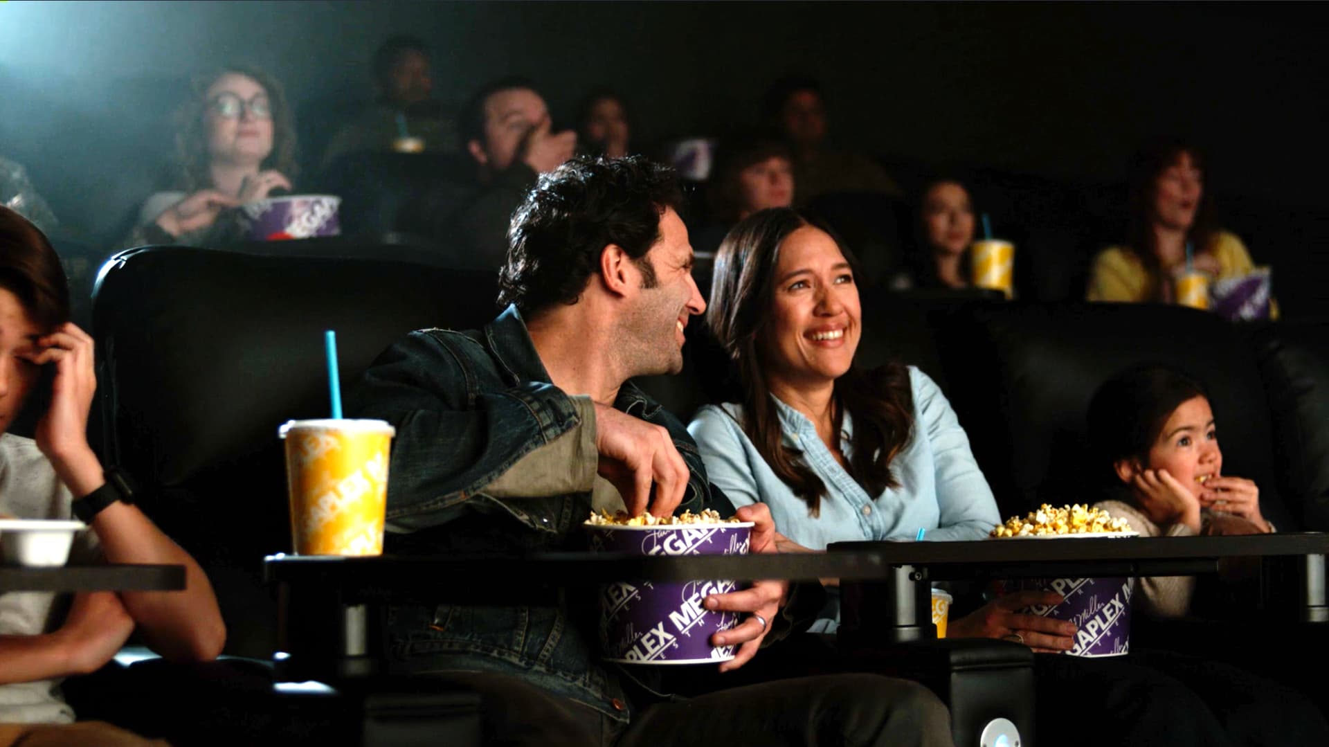 Family watching a movie in a Megaplex Theater